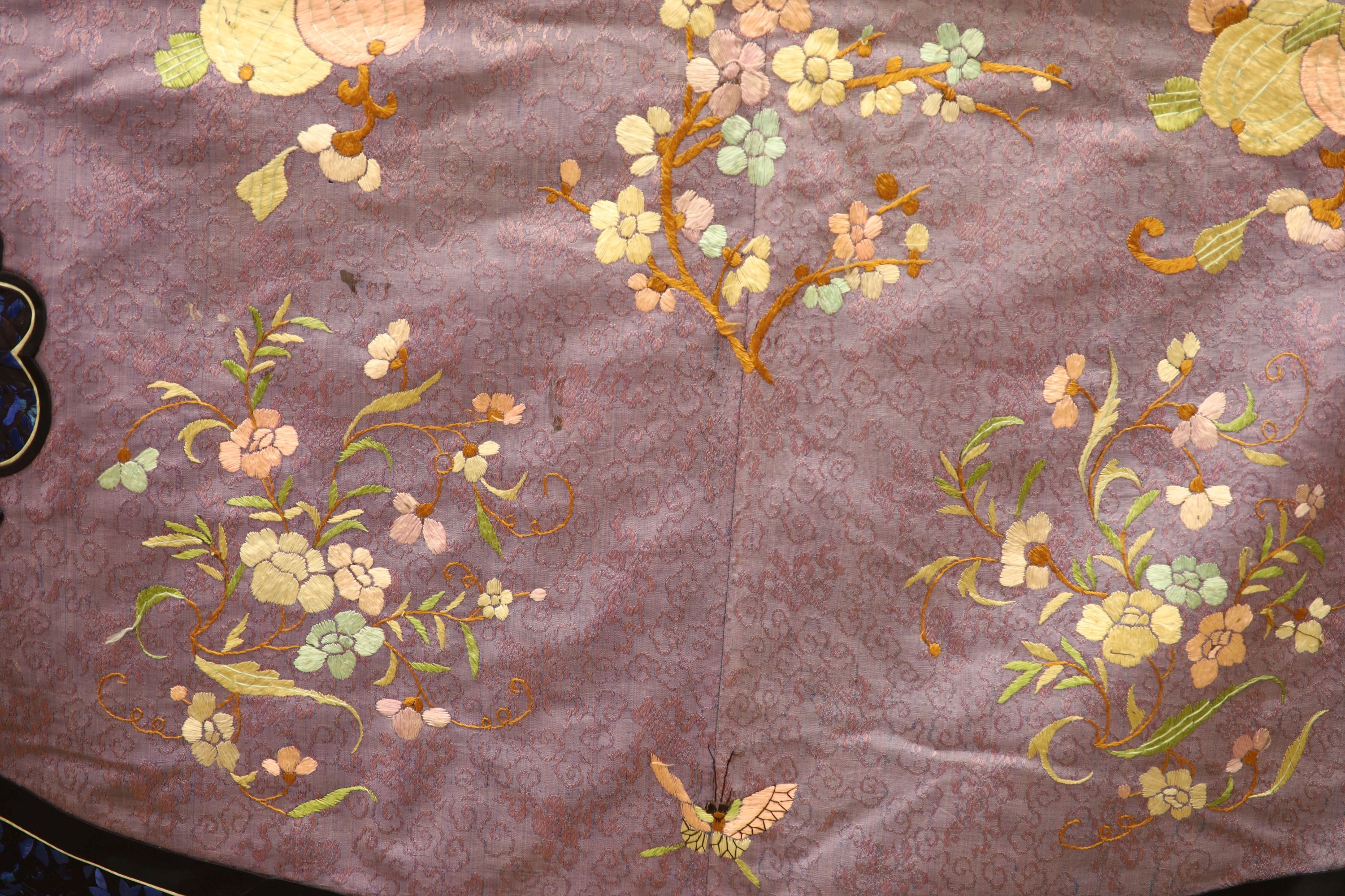 A Chinese lilac silk embroidered robe, early 20th century with multi-coloured embroidery and wide embroidered sleeve bands,